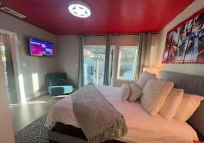 a bedroom with a large bed with a red ceiling at MagicwayVillas HeroHouse Pool and Spa in Fullerton
