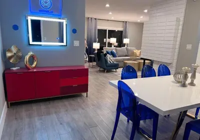 a living room with a table and blue chairs at MagicwayVillas HeroHouse Pool and Spa in Fullerton