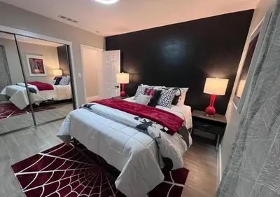a bedroom with a large bed and a large mirror at MagicwayVillas HeroHouse Pool and Spa in Fullerton