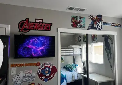 a bedroom with a room with avengers stickers on the wall at MagicwayVillas HeroHouse Pool and Spa in Fullerton