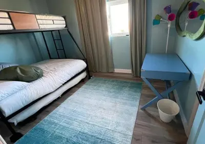 a small bedroom with a bed and a blue table at MagicwayVillas Avetar Villa - 5 Bedroom 3 Bath - Spa and Splash Pad in Anaheim