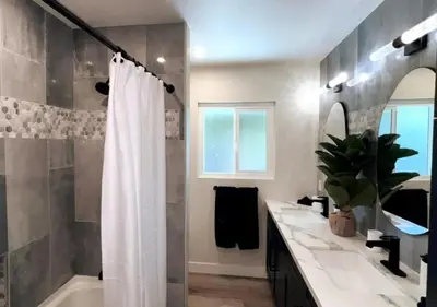 a bathroom with a shower and a white shower curtain at MagicwayVillas Avetar Villa - 5 Bedroom 3 Bath - Spa and Splash Pad in Anaheim