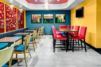 a row of tables and chairs in a restaurant at TownePlace Suites by Marriott Bakersfield West in Bakersfield
