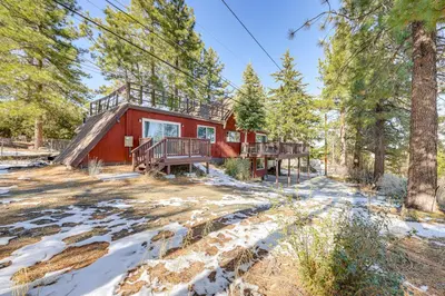 a house in the woods with snow on the ground at Wraparound Deck and Grill Wrightwood Cabin Near PCT in Wrightwood