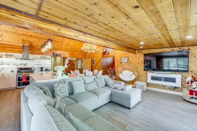 a living room with a couch and a kitchen at Wraparound Deck and Grill Wrightwood Cabin Near PCT in Wrightwood