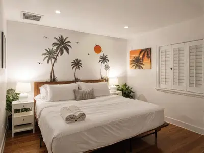 a bedroom with a large white bed with two towels on it at Fire Pit & Game Room 4 Beds Near Beach, LAX & SoFi in Lawndale