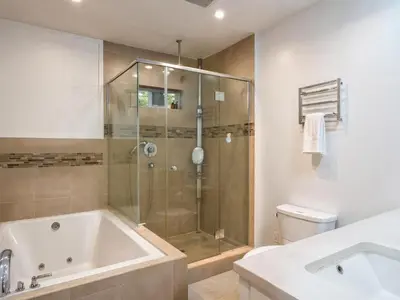 a bathroom with a shower and a tub and a toilet at Fire Pit & Game Room 4 Beds Near Beach, LAX & SoFi in Lawndale