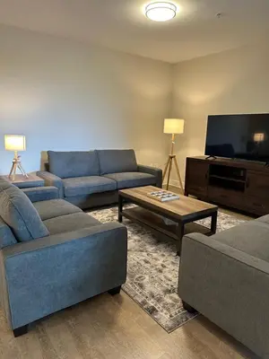 a living room with couches and a flat screen tv at Avalon Wilshire in Los Angeles