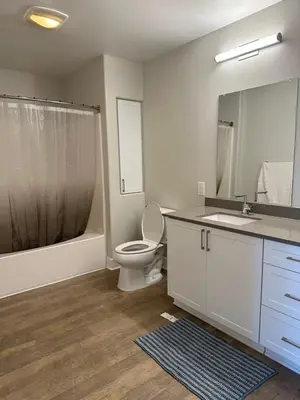 a bathroom with a toilet and a sink and a mirror at Avalon Wilshire in Los Angeles