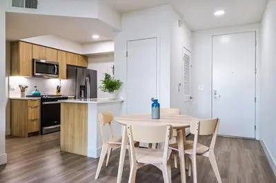 a kitchen and dining room with a table and chairs at Spacious 2BDR in SM - 5 minutes walk to the beach! in Los Angeles