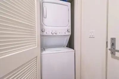 a washer and dryer in a small room at Spacious 2BDR in SM - 5 minutes walk to the beach! in Los Angeles
