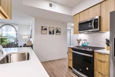 a kitchen with a sink and a stove top oven at Spacious 2BDR in SM - 5 minutes walk to the beach! in Los Angeles