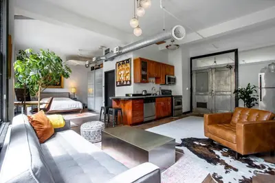 a living room with a couch and a table at City Lights Loft Downtown LA Month Plus in Los Angeles