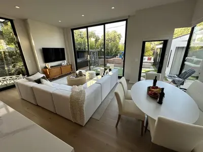 a living room with a white couch and a table at Zenice Beach Luxury Home - Sauna, Cold Plunge, Spa in Los Angeles