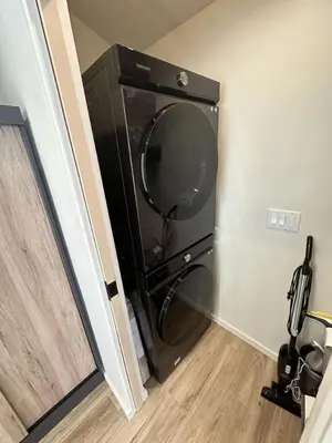 a black dishwasher in a corner of a room at Zenice Beach Luxury Home - Sauna, Cold Plunge, Spa in Los Angeles