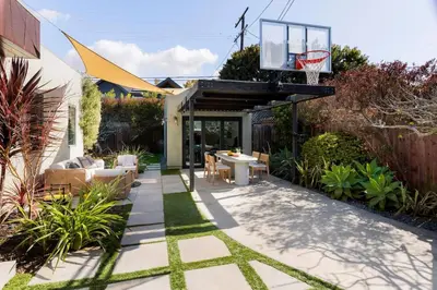 a backyard with a basketball hoop on a patio at Sun-Drenched Spanish Manor Home in Mar Vista in Los Angeles