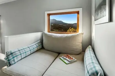 a living room with a couch and a window at Hillside Hideaway with Deck And Spa in Topanga Canyon in Topanga