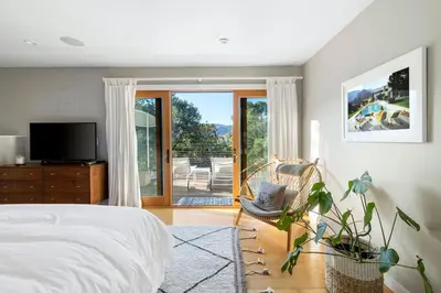 a bedroom with a bed and a sliding glass door at Hillside Hideaway with Deck And Spa in Topanga Canyon in Topanga