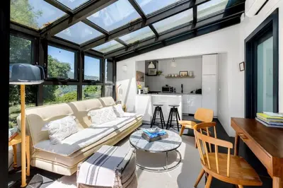 a living room with a couch and a table at Canyon Crest Cottage and Garden in Topanga Canyon in Topanga