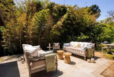 a patio with two chairs and a couch at Canyon Crest Cottage and Garden in Topanga Canyon in Topanga