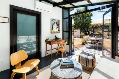 a living room with a couch and a table at Canyon Crest Cottage and Garden in Topanga Canyon in Topanga