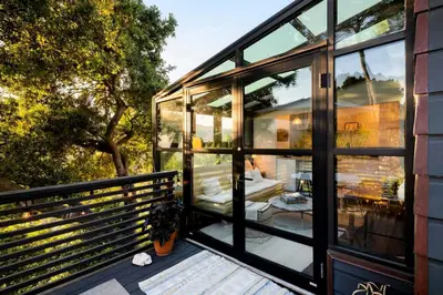 a glass house with a view of the backyard at Canyon Crest Cottage and Garden in Topanga Canyon in Topanga