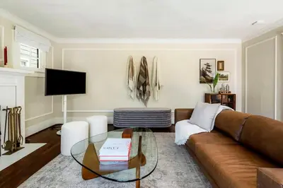 a living room with a couch and a glass table at Charming Walk Street Home - A Venice Beach Hideaway in Los Angeles