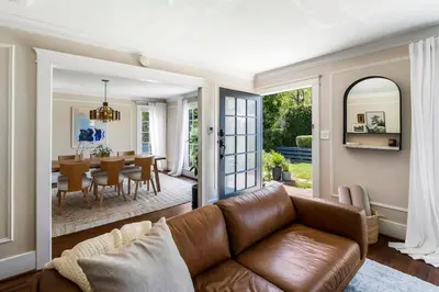a living room with a couch and a dining room at Charming Walk Street Home - A Venice Beach Hideaway in Los Angeles
