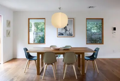 a dining room with a wooden table and chairs at San Juan Featured in Architectural Digest Plus Sauna in Los Angeles