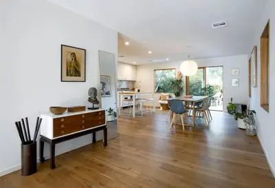 a living room with a table and a dining room at San Juan Featured in Architectural Digest Plus Sauna in Los Angeles