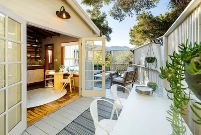a patio with a table and chairs on a balcony at Hillside Hideaway Guest House in Topanga Canyon in Topanga