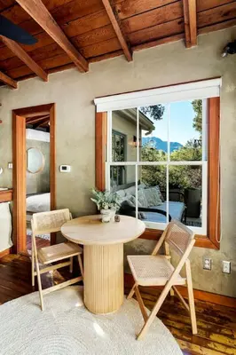 a table and chairs in a room with a window at Hillside Hideaway Guest House in Topanga Canyon in Topanga