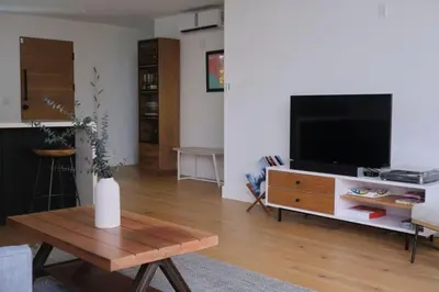 a living room with a television and a coffee table at Westminster Bungalow - Front House with Private Entrance in Los Angeles