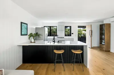 a kitchen with a large island with stools in it at Westminster Bungalow - Front House with Private Entrance in Los Angeles