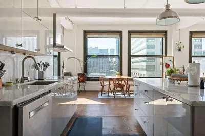 a kitchen with stainless steel appliances and a dining room at Skyline View Loft w Kitchen DTLA Exclusively Month Plus in Los Angeles