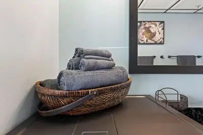 a basket filled with towels on a table in a bathroom at Skyline View Loft w Kitchen DTLA Exclusively Month Plus in Los Angeles