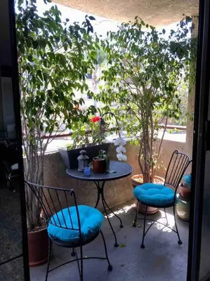 a patio with two chairs and a table and a tree at Best Location West LA Spacious condo with hottub in Los Angeles