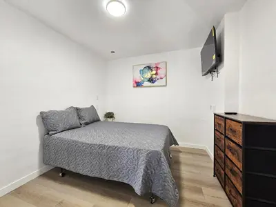 a bedroom with a bed and a dresser and a television at Sunrise Inn in Inyokern