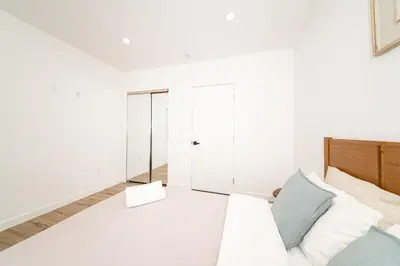 a white room with a couch and a closet at A Brand New Home In Los Angeles in Van Nuys County Court Heliport