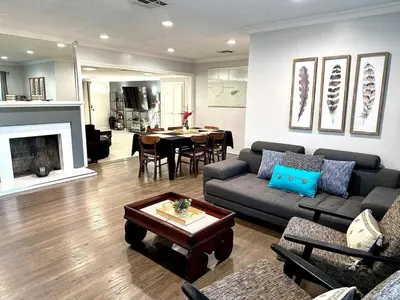 a living room with a couch and a table at Tranquil Poolside Oasis with BBQ and Serene Ambiance in North Hollywood