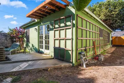 a green and white house with a porch at Steps to Venice Beach Vintage Venice Retreat in Los Angeles