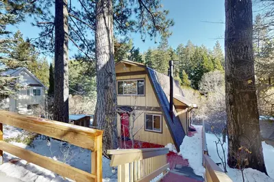 a cabin in the woods in the snow at Whistle Stop Cabin in Lake Arrowhead