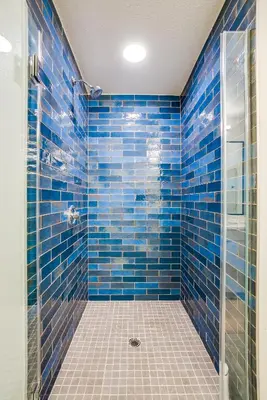 a blue tiled bathroom with a glass shower at View of Hollywood Sign Studio, Free Parking in Los Angeles