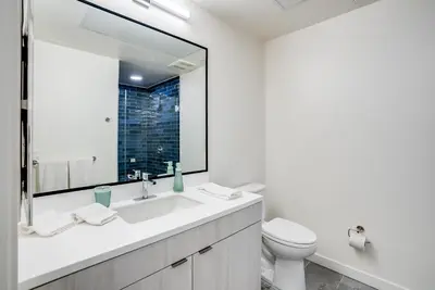 a bathroom with a sink and a toilet and a mirror at View of Hollywood Sign Studio, Free Parking in Los Angeles