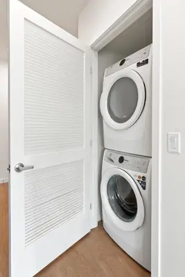 a washer and dryer in a white laundry room at Bright Studio on Sunset Blvd, Free Parking, Gym, and Pool in Los Angeles