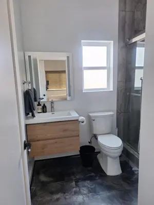 a bathroom with a toilet and a sink and a shower at Azusa in Azusa