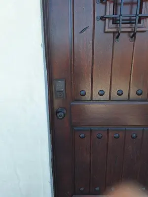 a brown wooden door with black knobs on it at Azusa in Azusa