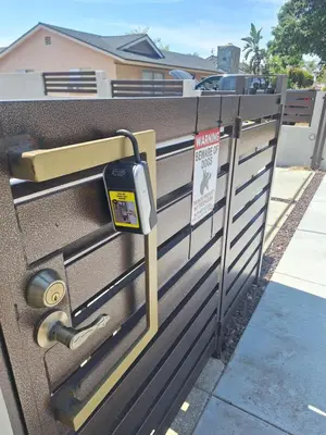 a parking meter on a fence with a no parking sign at Azusa in Azusa