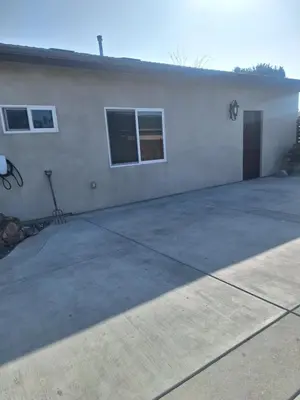 a large white building with a door and two windows at Beautiful and cosy home in Azusa