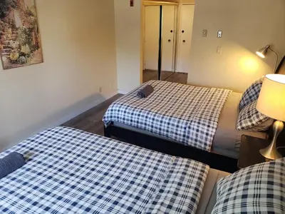 a room with two beds and a lamp in it at Beverly Hills Studios in Los Angeles